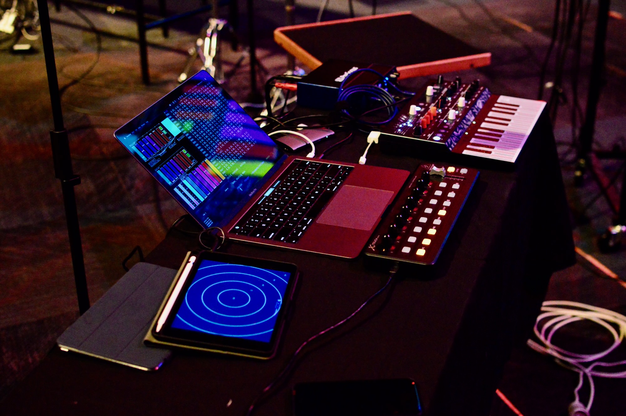 A laptop and MIDI interface setup for an IMPS performance in a concert hall.