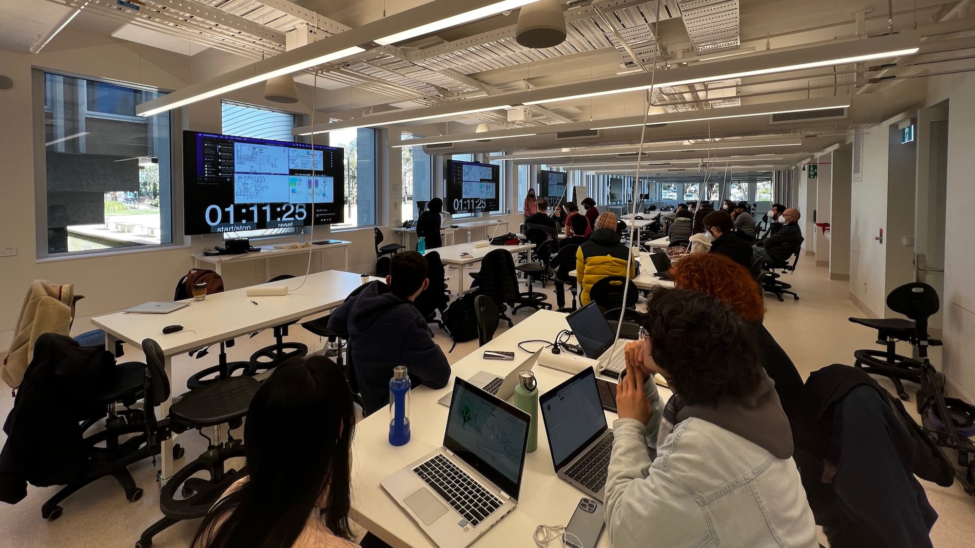 Students watching laptop screens during a workshop session in 2022