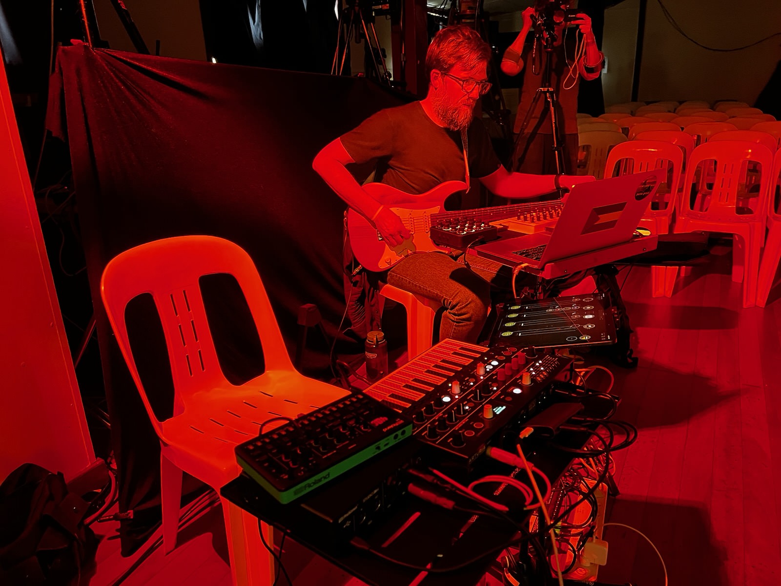 More rehearsals under red lighting.