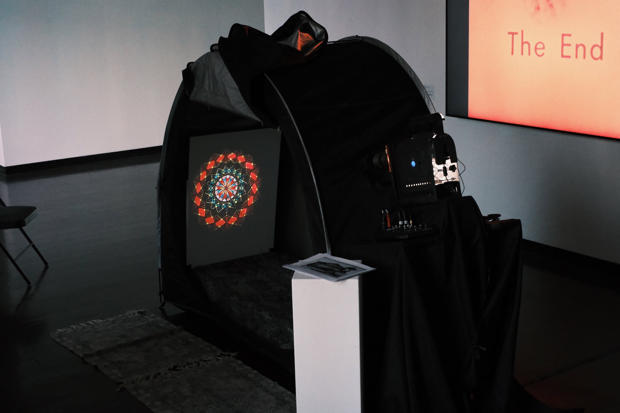 The Dream Tent in operation, during the installation the sound is diffused quietly via small loudspeakers under the couch, inviting visitors to enter and experience full immersion with the side panel closed.