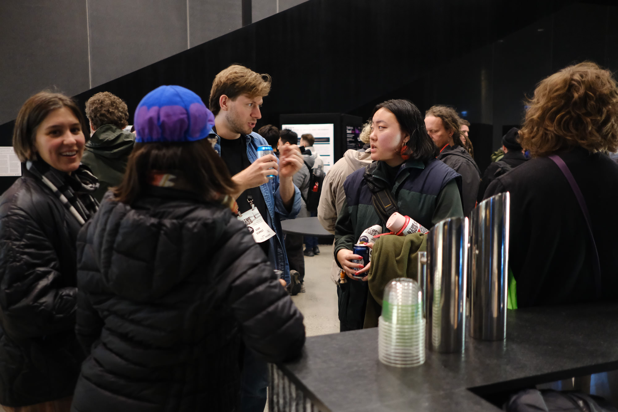 Adam Schmidt and Sandy Ma discussing at the opening event.