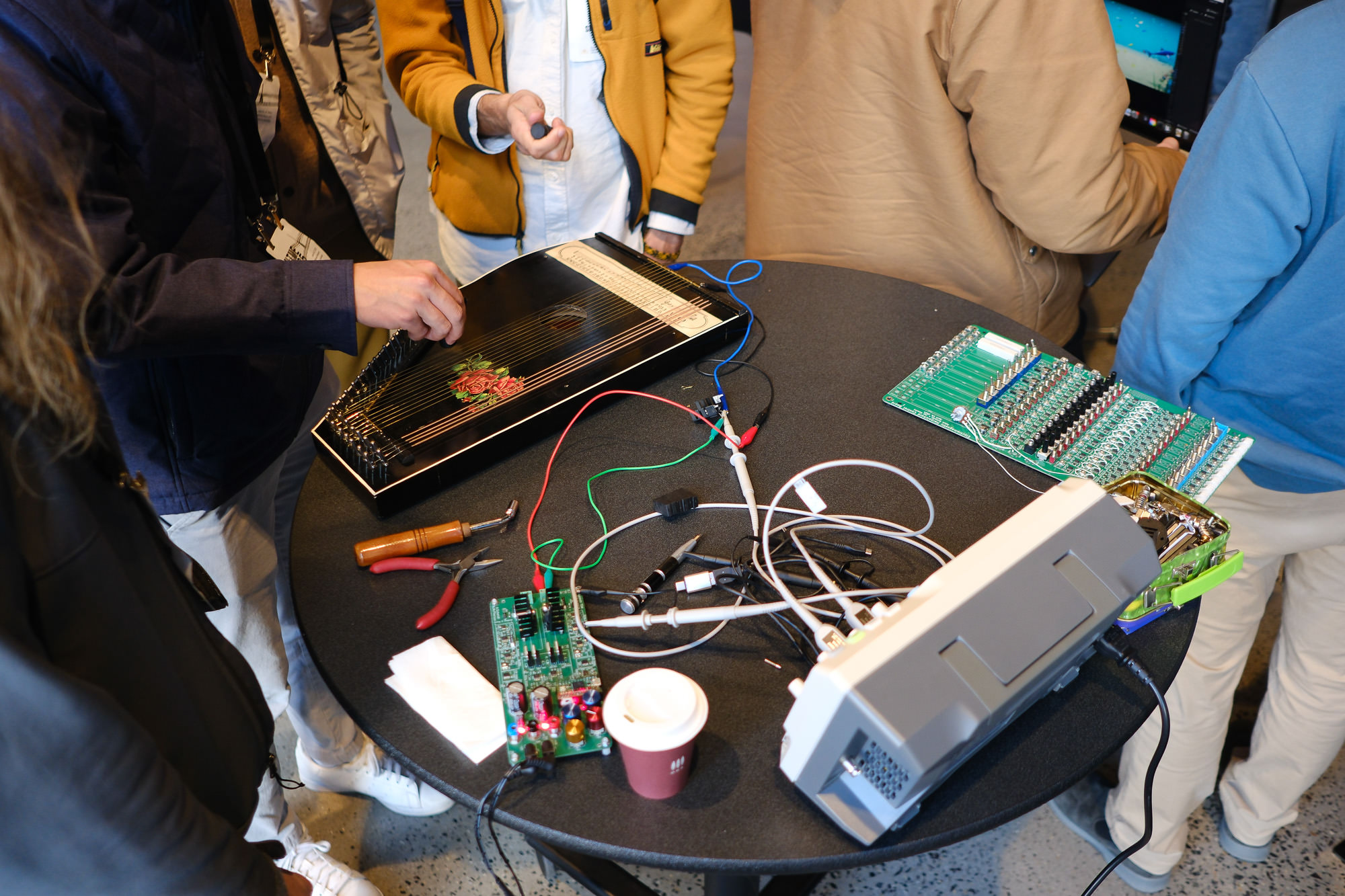 NIMErs gather around the oscilloscope for an exciting demonstration at the Poster 2 session.