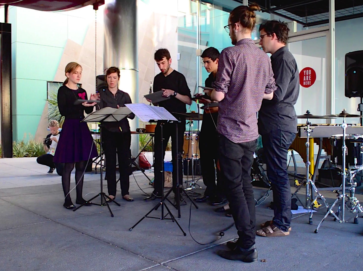 An ensemble of percussionists performing Gesture Study 1 on iPads