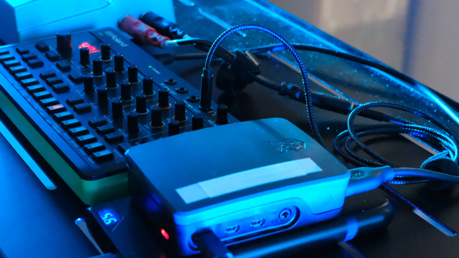 An IMPSY-driven Korg S-1 synthesizer in performance, with a Raspberry Pi controller running the predictive model.